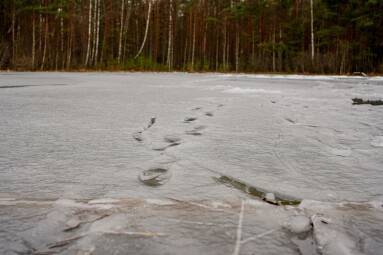 Frozen,Lake,In,Spring,With,Melting,Ice,,Footprints,Visible,On