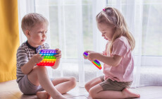 Blonde,Boy,And,Girl,Children,Sit,On,The,Floor,Near