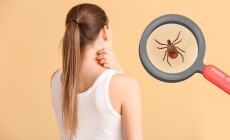 Young,Woman,Scratching,Her,Skin,And,Tick,Visible,Through,Magnifying