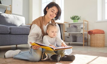 Loving,Happy,Young,Mother,,Babysitter,And,Little,Child,Reading,Book,