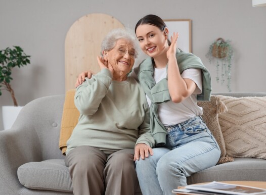 Senior,Woman,And,Her,Granddaughter,With,Hearing,Aids,Hugging,On