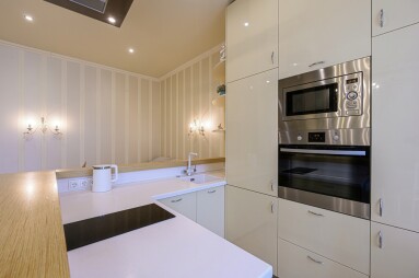 Modern,Kitchen,With,Cream,Cabinets,,Stainless,Steel,Appliances,,A,White