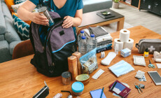 Unrecognizable,Woman,Putting,Cans,Of,Food,To,Prepare,Emergency,Backpack