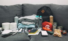 Emergency,Backpack,Equipment,Organized,On,The,Table.,Documents,,Water,food,,First