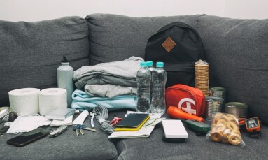 Emergency,Backpack,Equipment,Organized,On,The,Table.,Documents,,Water,food,,First