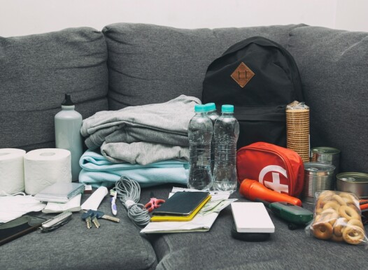 Emergency,Backpack,Equipment,Organized,On,The,Table.,Documents,,Water,food,,First