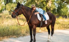 Cute,Little,Girl,With,Long,Hair,Riding,A,Horse,Outdoors.