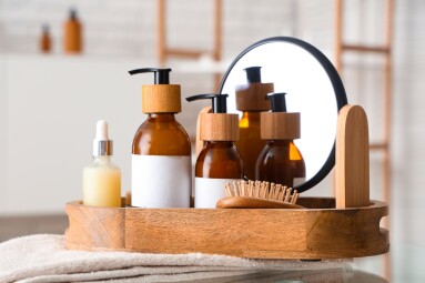 Bottles,Of,Cosmetic,Products,And,Bath,Supplies,In,Wooden,Tray