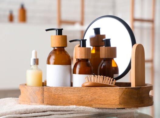 Bottles,Of,Cosmetic,Products,And,Bath,Supplies,In,Wooden,Tray