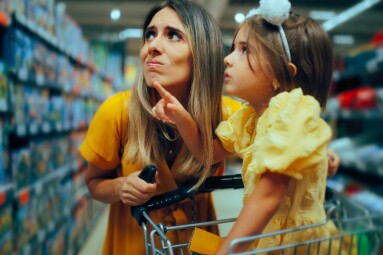 Little,Girl,Showing,Her,Mother,What,She,Wants,To,Buy.