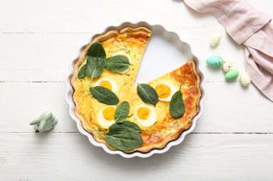 Cut,Easter,Egg,Tart,With,Spinach,Leaves,And,Toy,Bunny