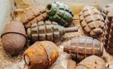 Old,Rusty,Grenades,Lying,On,The,Table
