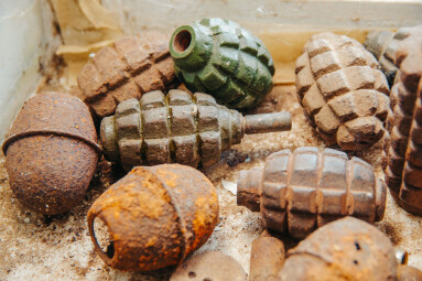 Old,Rusty,Grenades,Lying,On,The,Table