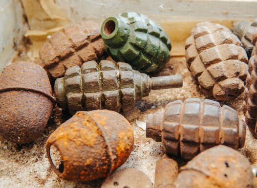 Old,Rusty,Grenades,Lying,On,The,Table
