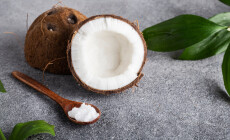 Wooden,Spoon,Of,Coconut,Oil,On,A,Gray,Table,Coconut
