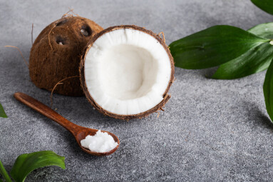 Wooden,Spoon,Of,Coconut,Oil,On,A,Gray,Table,Coconut