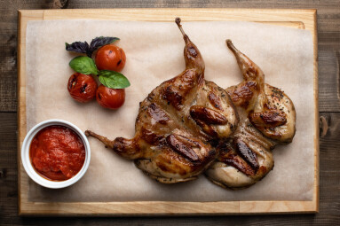 Quail,Grill,On,A,Wooden,Board,With,Cherry,Tomatoes,And
