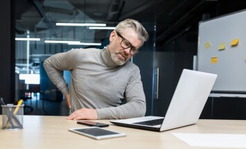 Sick,Senior,Man,Working,Inside,Office,Modern,Building,,Overtired,Mature