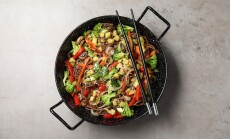 Stir-fry.,Tasty,Noodles,With,Meat,In,Wok,And,Chopsticks,On