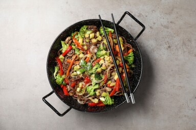 Stir-fry.,Tasty,Noodles,With,Meat,In,Wok,And,Chopsticks,On