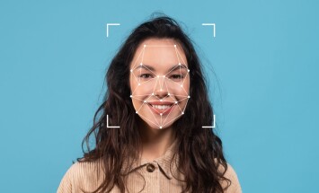 A,Woman,Is,Smiling,While,Facial,Recognition,Dots,Are,Mapped