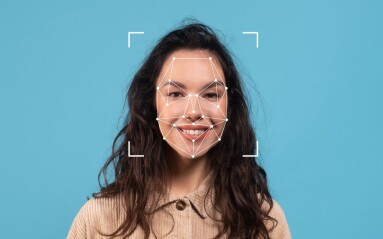 A,Woman,Is,Smiling,While,Facial,Recognition,Dots,Are,Mapped