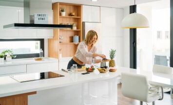 Woman,Adding,Blueberries,To,Blender,For,Healthy,Smoothie