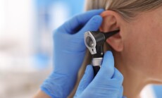 Hearing,Test.,Doctor,Examining,Woman's,Ear,With,Otoscope,In,Clinic,