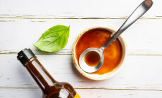 Worcestershire,Sauce,In,A,Bowl,With,Spoon,And,Bottle,Over