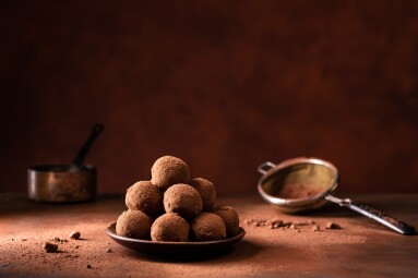Tasty,Dark,Chocolate,Truffles,With,Cocoa,Dusting,On,A,Brown