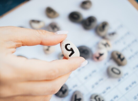Woman,Numerologist,Hand,With,Pebble,Stone,With,Number,Five,5.