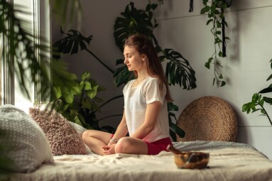 Young,Attractive,Woman,Practices,Yoga,At,Home,sitting,Cross-legged.yoga,Mudra.relaxation,And