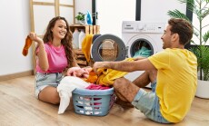 Man,And,Woman,Couple,Cleaning,Clothes,Using,Washing,Machine,At