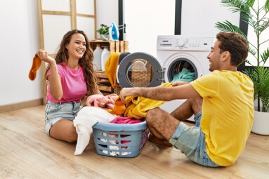 Man,And,Woman,Couple,Cleaning,Clothes,Using,Washing,Machine,At