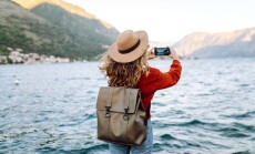 Female,Traveler,In,Casual,Sweater,Taking,Picture,Of,Amazing,Landscape