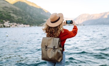 Female,Traveler,In,Casual,Sweater,Taking,Picture,Of,Amazing,Landscape