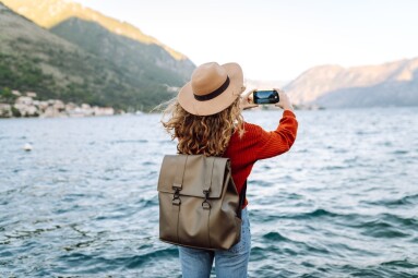 Female,Traveler,In,Casual,Sweater,Taking,Picture,Of,Amazing,Landscape