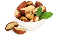 Tasty,Brazil,Nuts,And,Green,Leaves,In,Bowl,Isolated,On