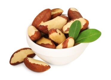 Tasty,Brazil,Nuts,And,Green,Leaves,In,Bowl,Isolated,On