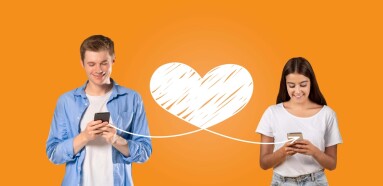 A,Young,Couple,Enjoys,Sharing,Affectionate,Messages,On,Their,Smartphones,