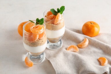 Glasses,With,Delicious,Tangerine,Cheesecake,On,White,Background