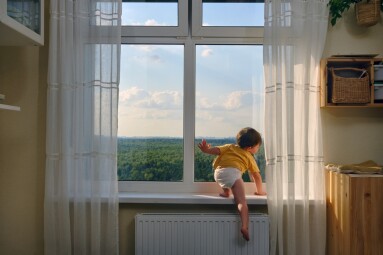 The,Little,Baby,Is,Dangerously,Climbing,Up,The,Window,Sill,