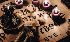 A,Dark,Atmospheric,Setting,With,An,Ouija,Board,,Candles,,And