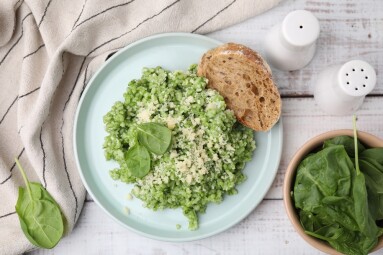 Tasty,Spinach,Risotto,Served,With,Bread,On,White,Wooden,Table,