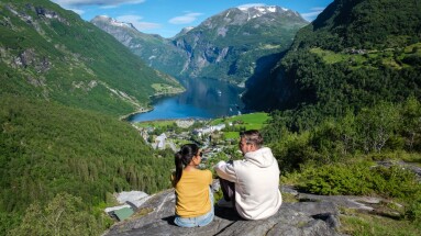 A,Couple,Relaxes,On,A,Rocky,Outcrop,Overlooking,The,Breathtaking