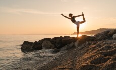 Woman,Practicing,Yoga,At,Seaside,At,Sunset,Or,Sunrise.,Young