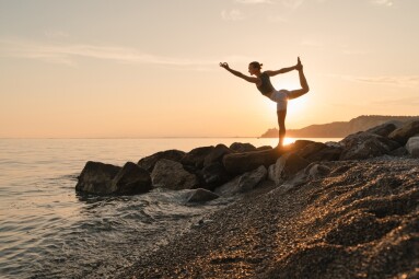 Woman,Practicing,Yoga,At,Seaside,At,Sunset,Or,Sunrise.,Young