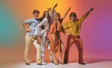 Friends,Posing,In,Playful,Retro,Disco,Costumes,Against,Colorful,Nostalgic