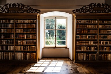 An,Old,Monastery,Library,With,A,Window,Where,Light,Streams