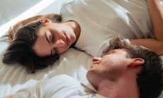 A,Young,Couple,Lies,On,A,Bed,In,Soft,Morning